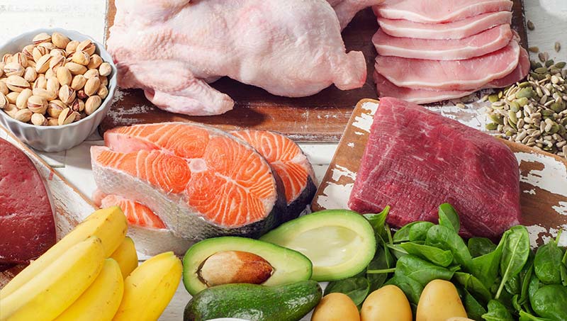 image of metabolism boosting foods, such as avacados, chicken, and salmon